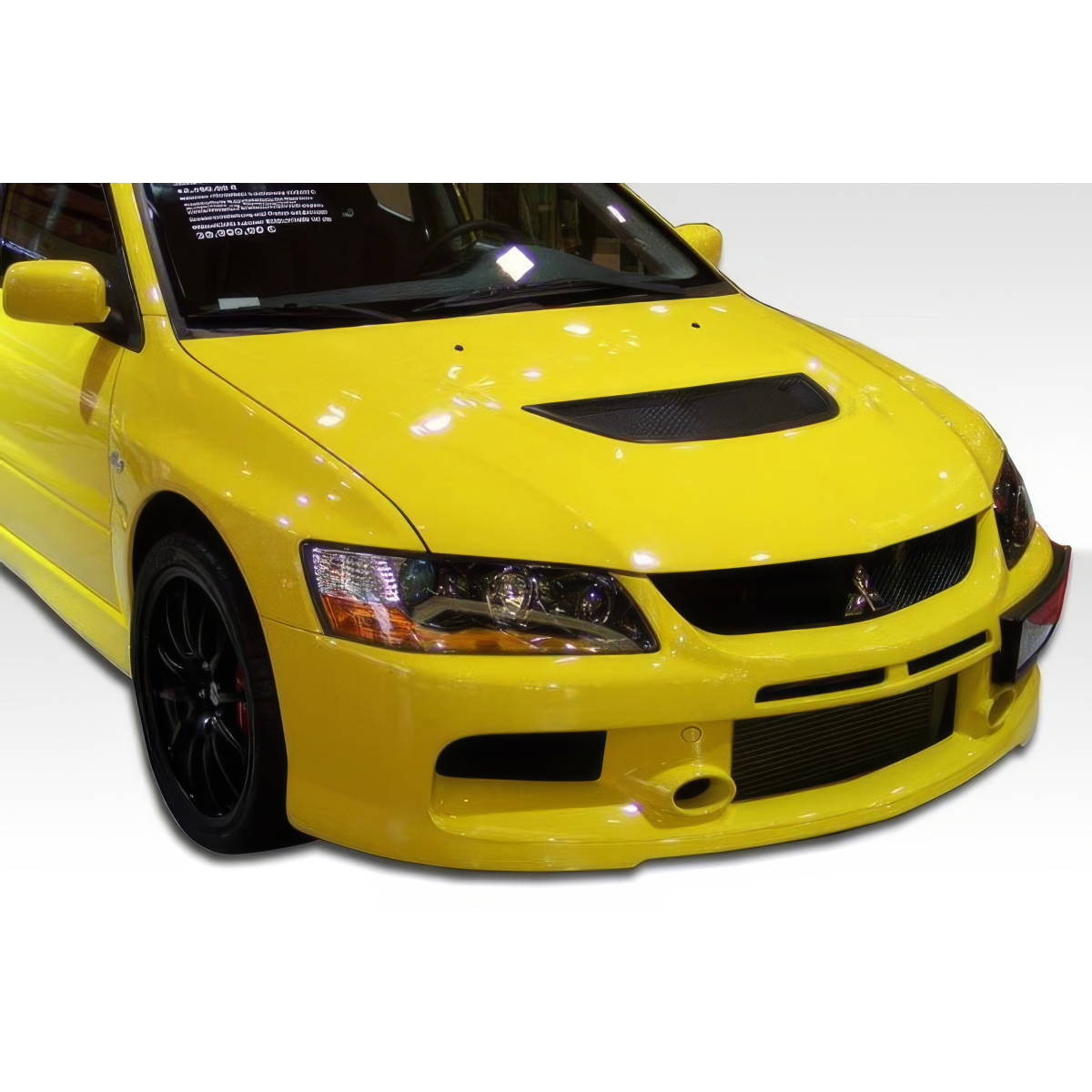 Modify your Mitsubishi Evolution 2003 with our Exterior/Front Bumpers or Lips - Front angle view of a yellow Mitsubishi Evolution