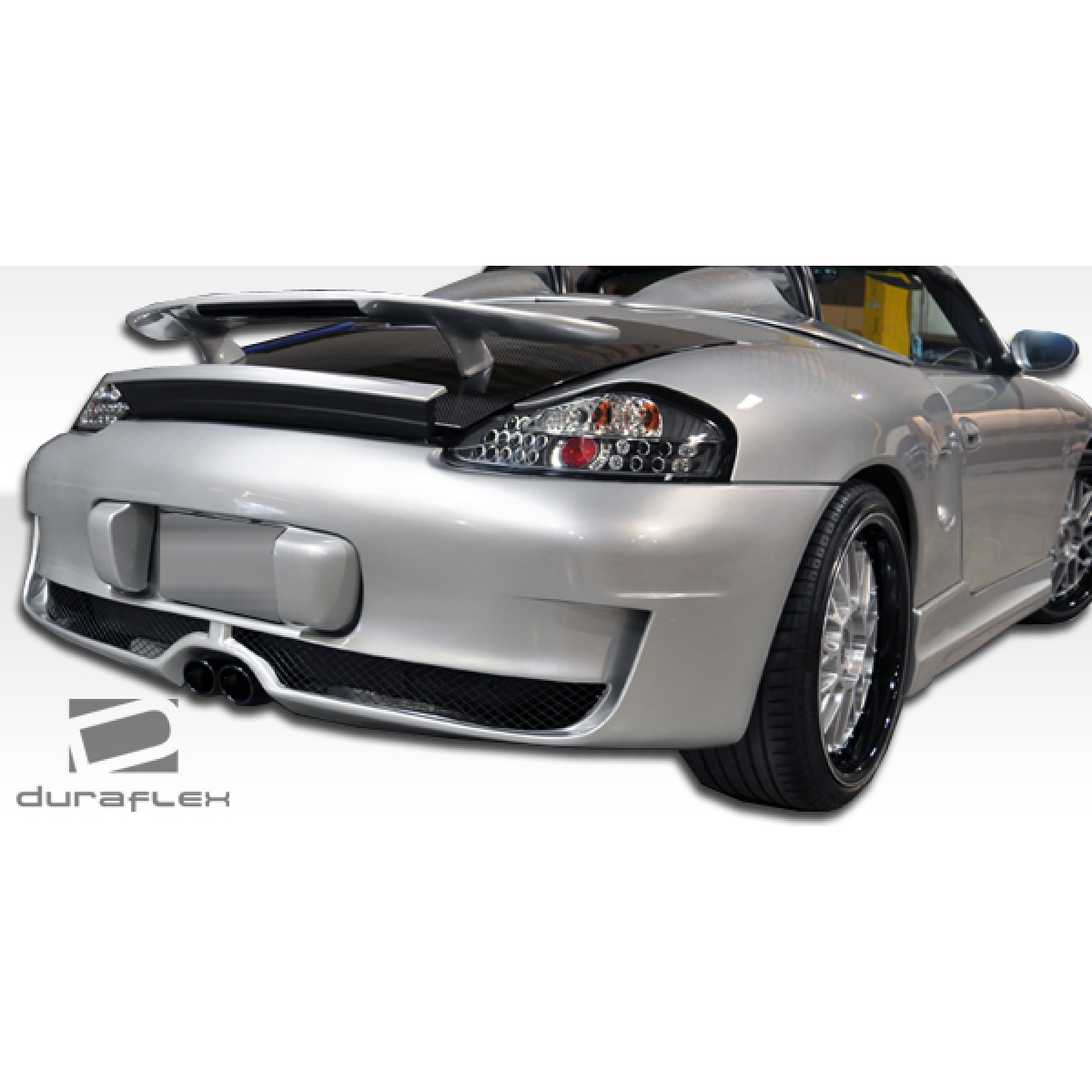 Modify your Porsche Boxster 1997 with our Exterior/Complete Body Kits - Rear angle view of the car showing side skirts