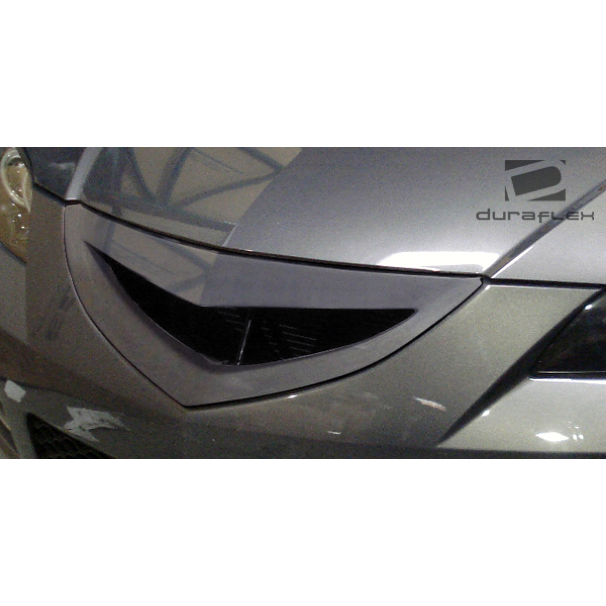 Modify your Mazda 3 2004 with our Exterior/Grilles - Front view showing grille at slight angle