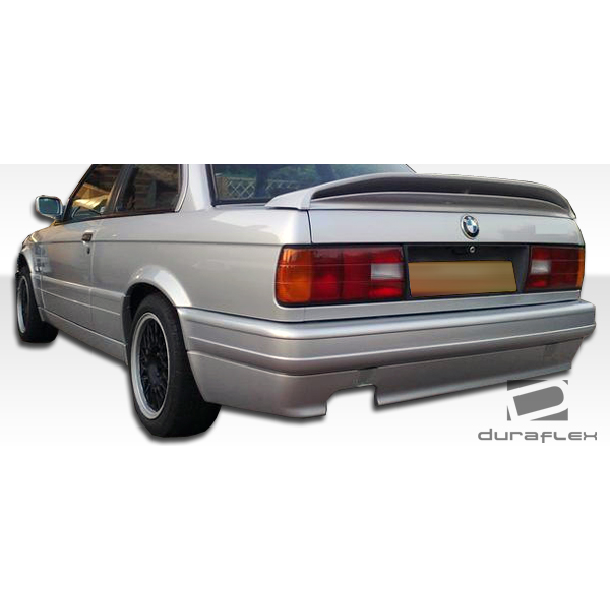 Modify your BMW 3-Series 1984 with our Exterior/Side Skirts - Rear angle view of BMW E30 showcasing side skirts