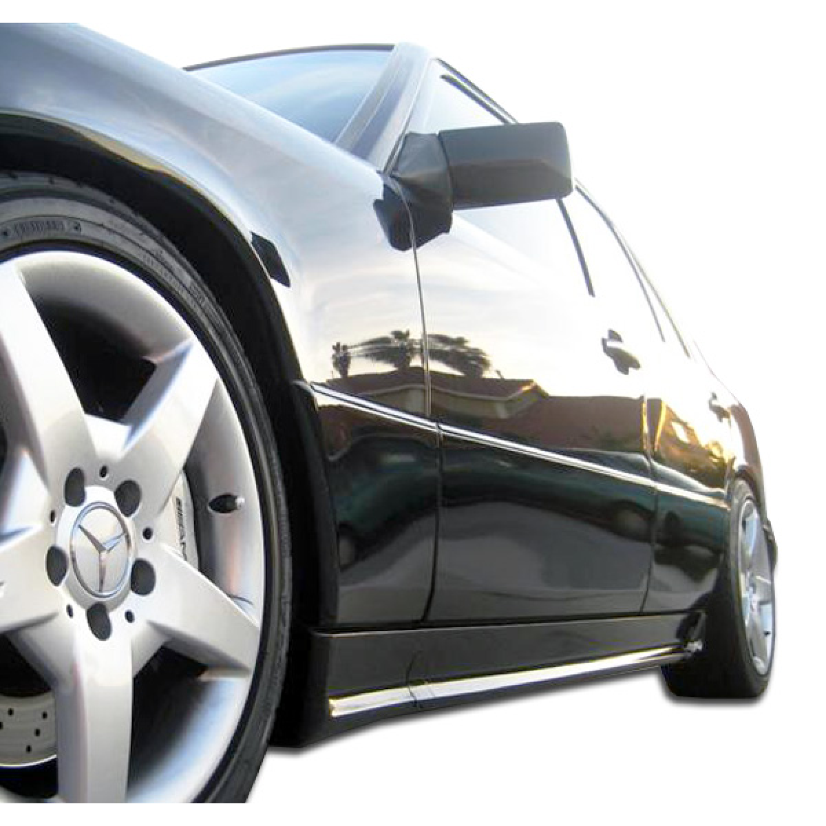 Modify your Mercedes-Benz E-Class 1986 with our Exterior/Side Skirts - Low angle view showcasing the car side