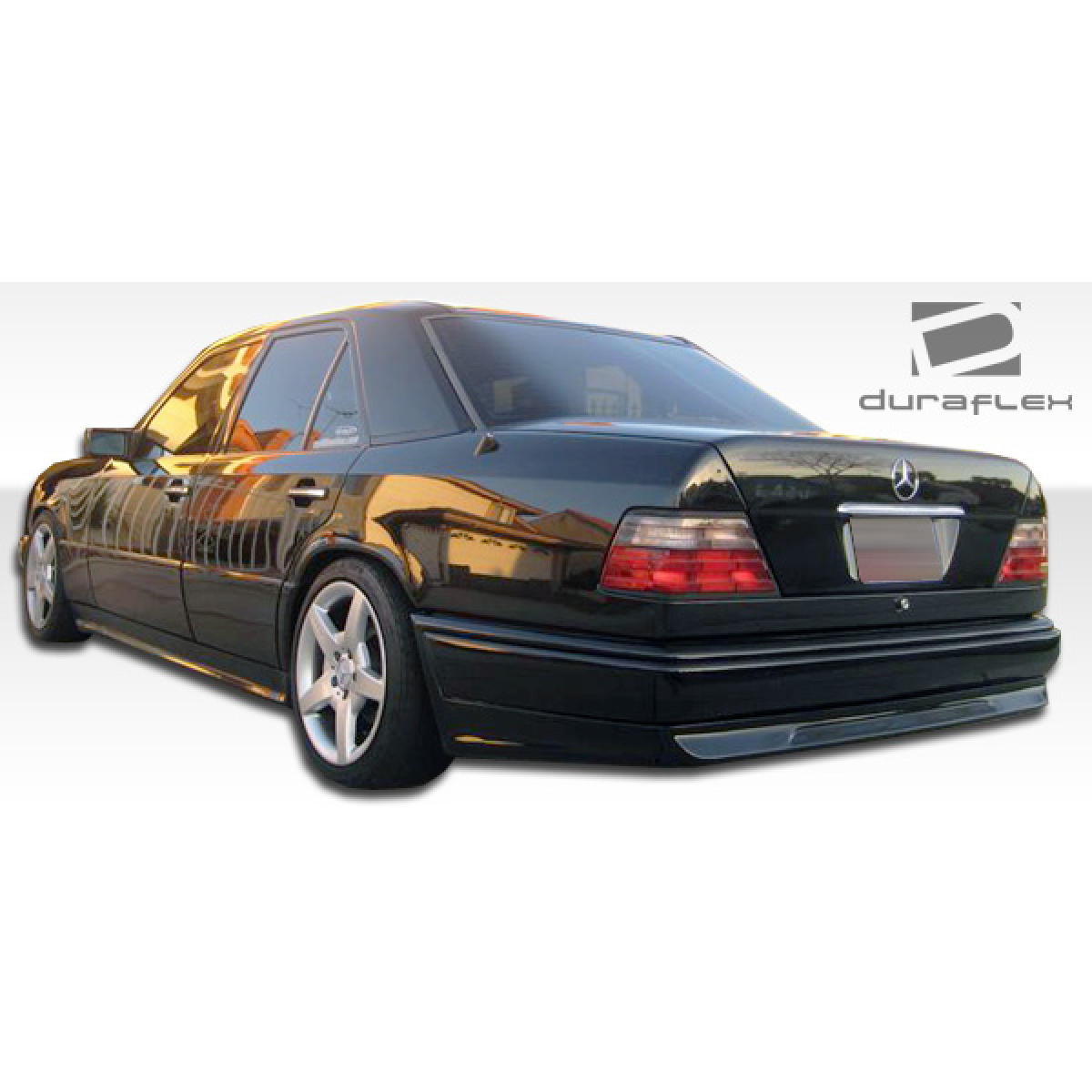 Modify your Mercedes-Benz E-Class 1986 with our Exterior/Side Skirts - Rear three quarter view of the vehicle