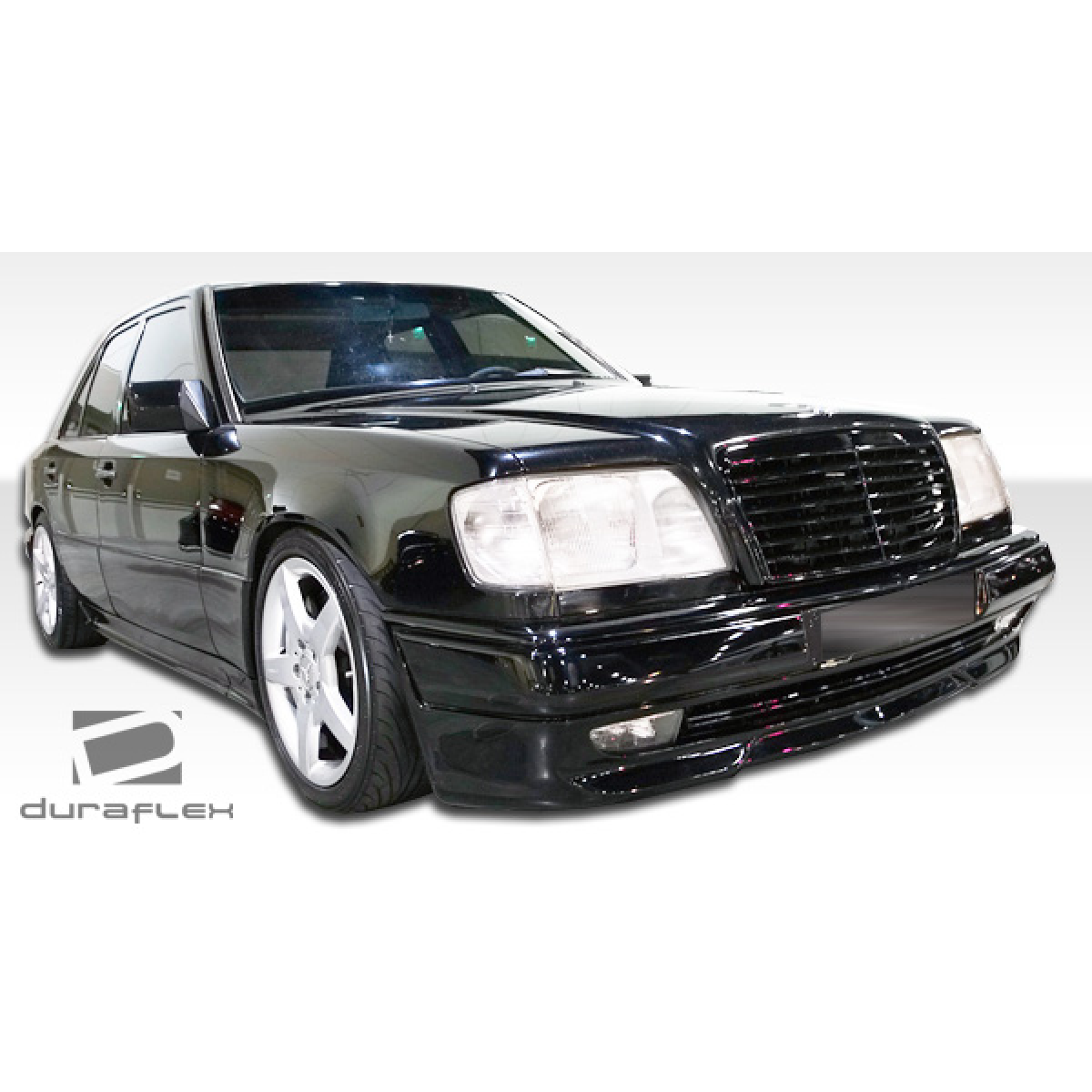 Modify your Mercedes-Benz E-Class 1986 with our Exterior/Side Skirts - The image is seen at a low angle from the front