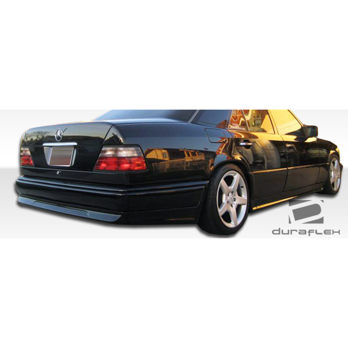 Modify your Mercedes-Benz E-Class 1986 with our Exterior/Side Skirts - View from slightly above and behind the vehicle