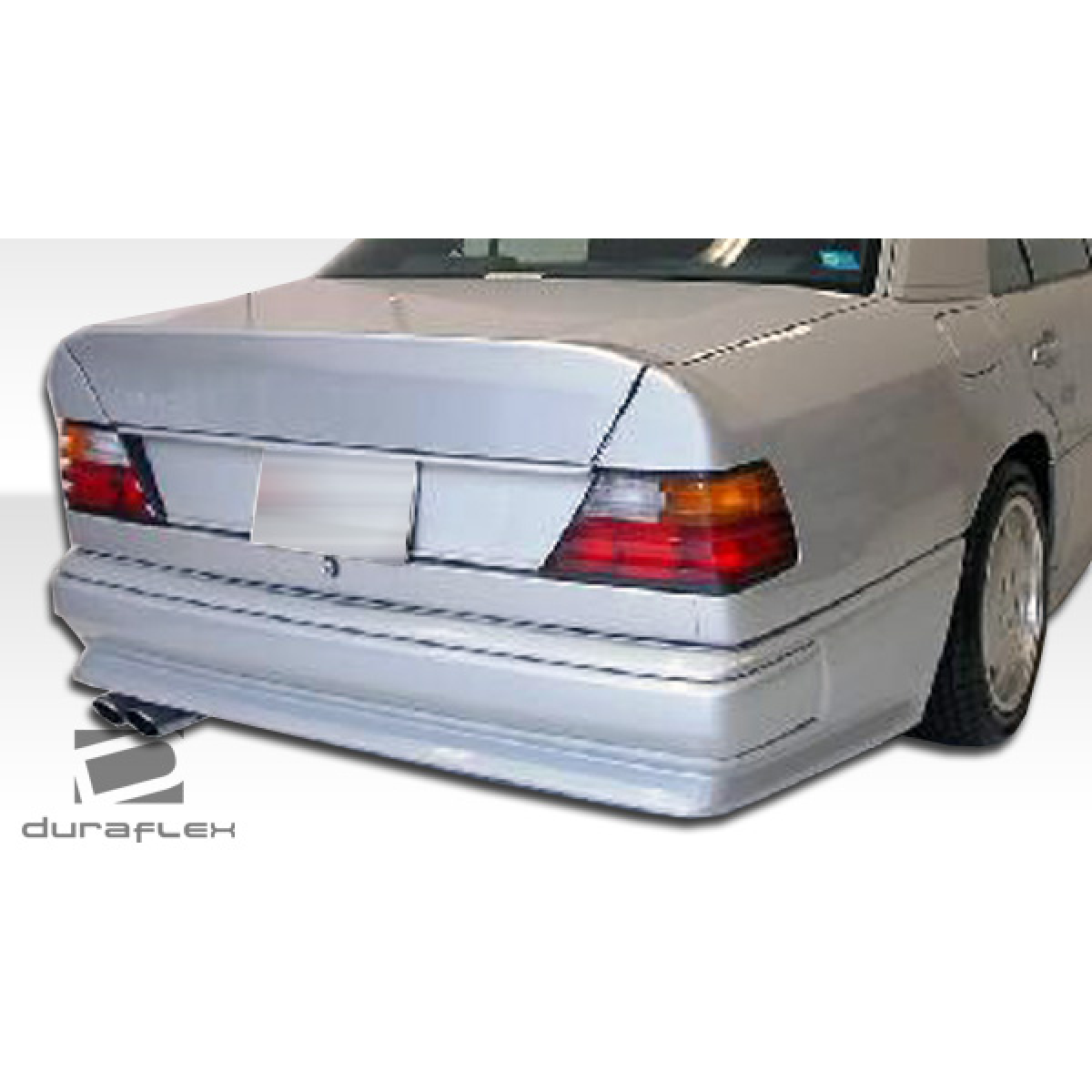 Modify your Mercedes-Benz E-Class 1986 with our Exterior/Complete Body Kits - Rear view angle showing bumper design details