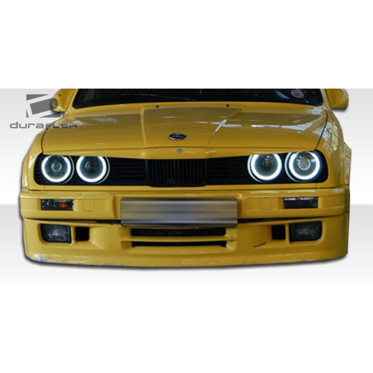 Modify your BMW 3-Series 1988 with our Exterior/Complete Body Kits - Front view of a yellow BMW E30 car