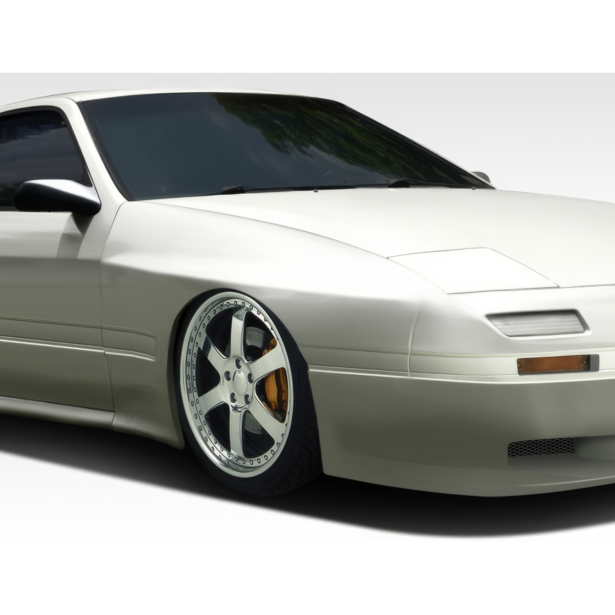 Modify your Mazda RX-7 1986 with our Exterior/Fenders - Front angle showcasing custom fender and wheel