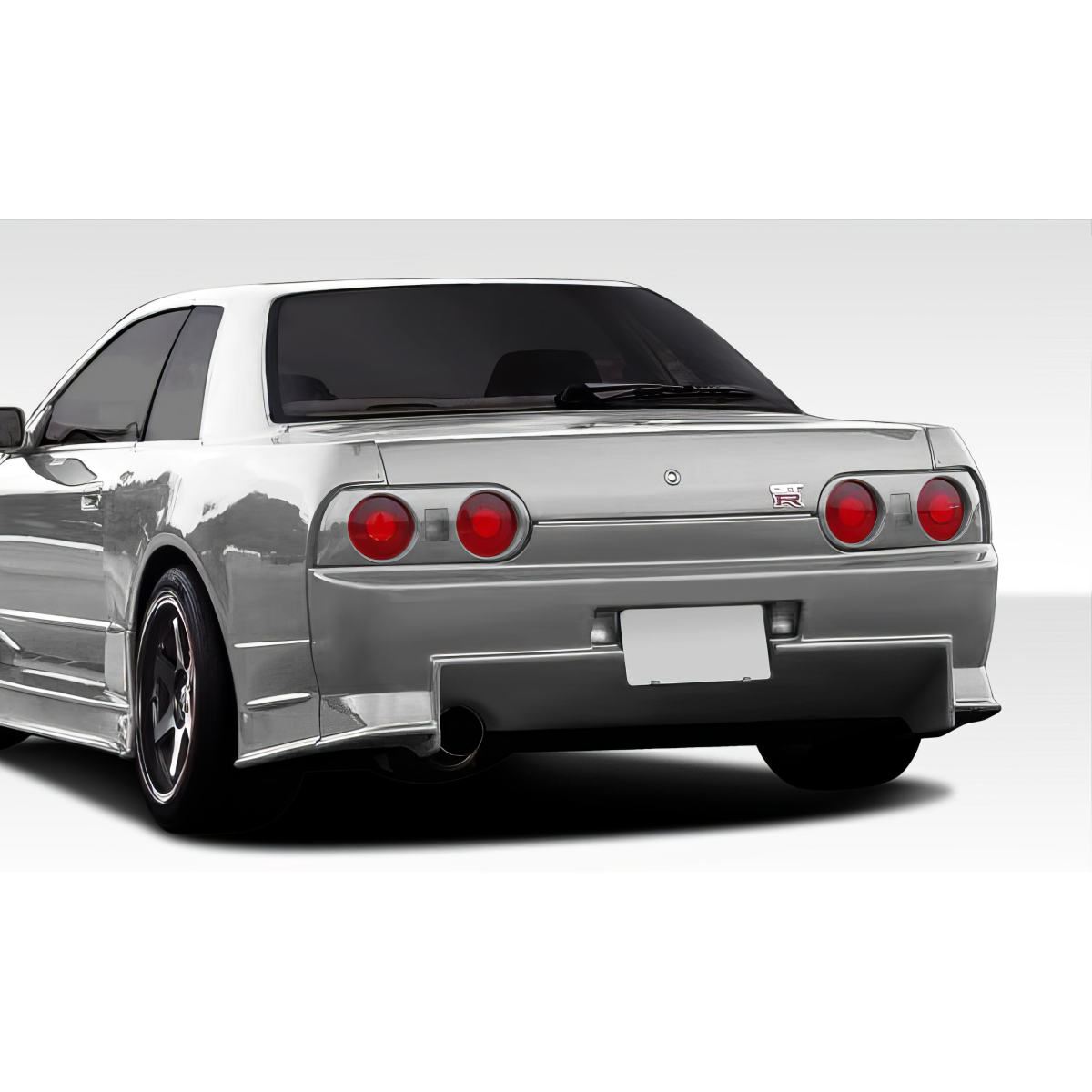 Modify your Nissan Skyline 1989 with our Exterior/Complete Body Kits - Rear angle view of vehicle showcasing bumper design