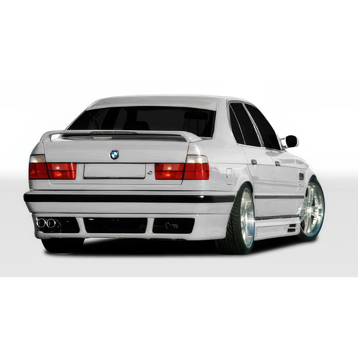 Modify your BMW 5-Series 1989 with our Exterior/Rear Bumpers or Lips - Rear view angle of a white BMW E34 5 Series