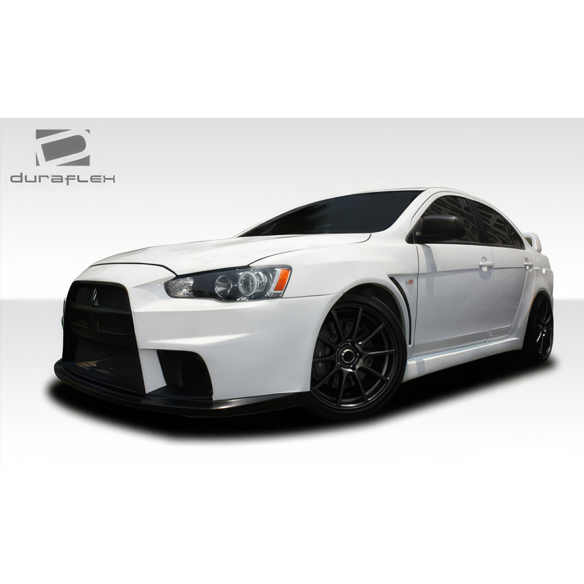 Modify your Mitsubishi Lancer 2008 with our Exterior/Complete Body Kits - Front angle view of a white Mitsubishi Lancer