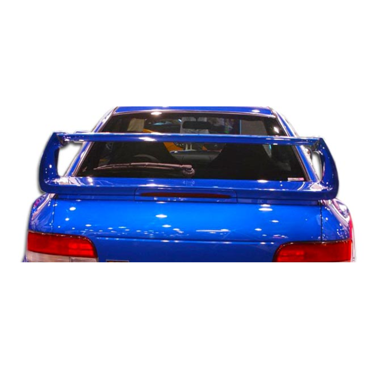 Modify your Subaru Impreza 1993 with our Exterior/Wings - Rear angle view of a blue Subaru Impreza