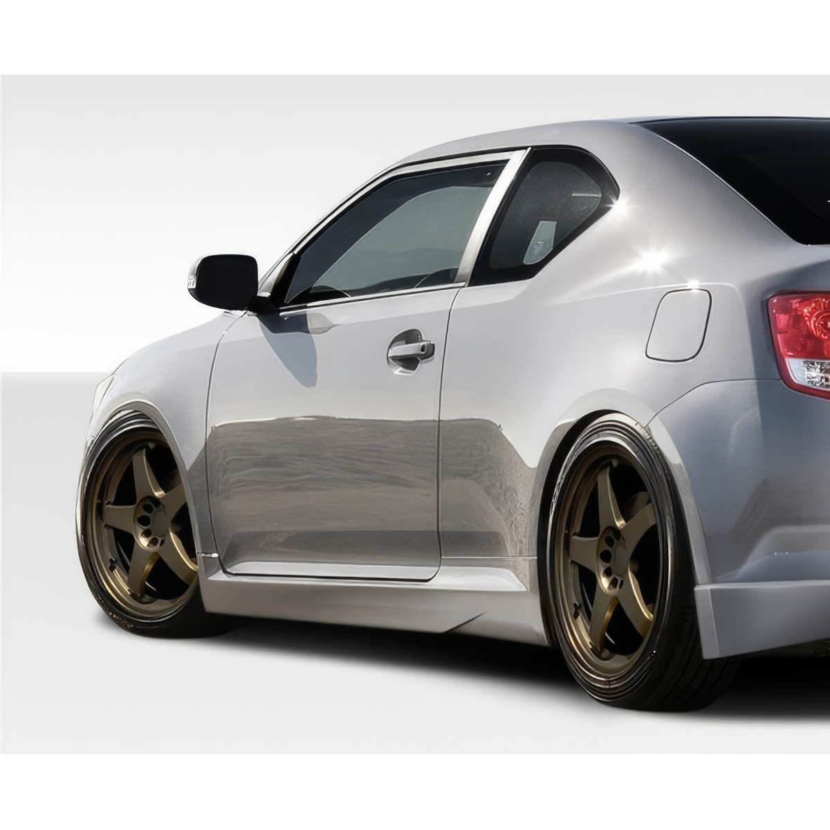 Modify your Scion tC 2011 with our Exterior/Side Skirts - Side angle view of a lowered silver Scion tC