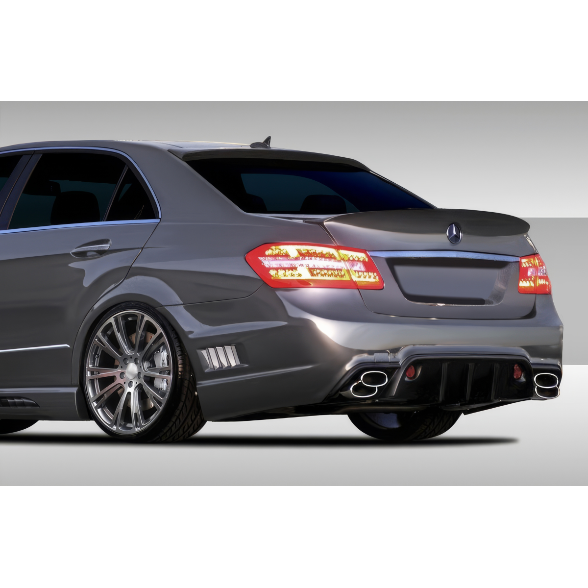 Modify your Mercedes-Benz E-Class 2010 with our Exterior/Rear Bumpers or Lips - Rear angle showcasing the bumper design