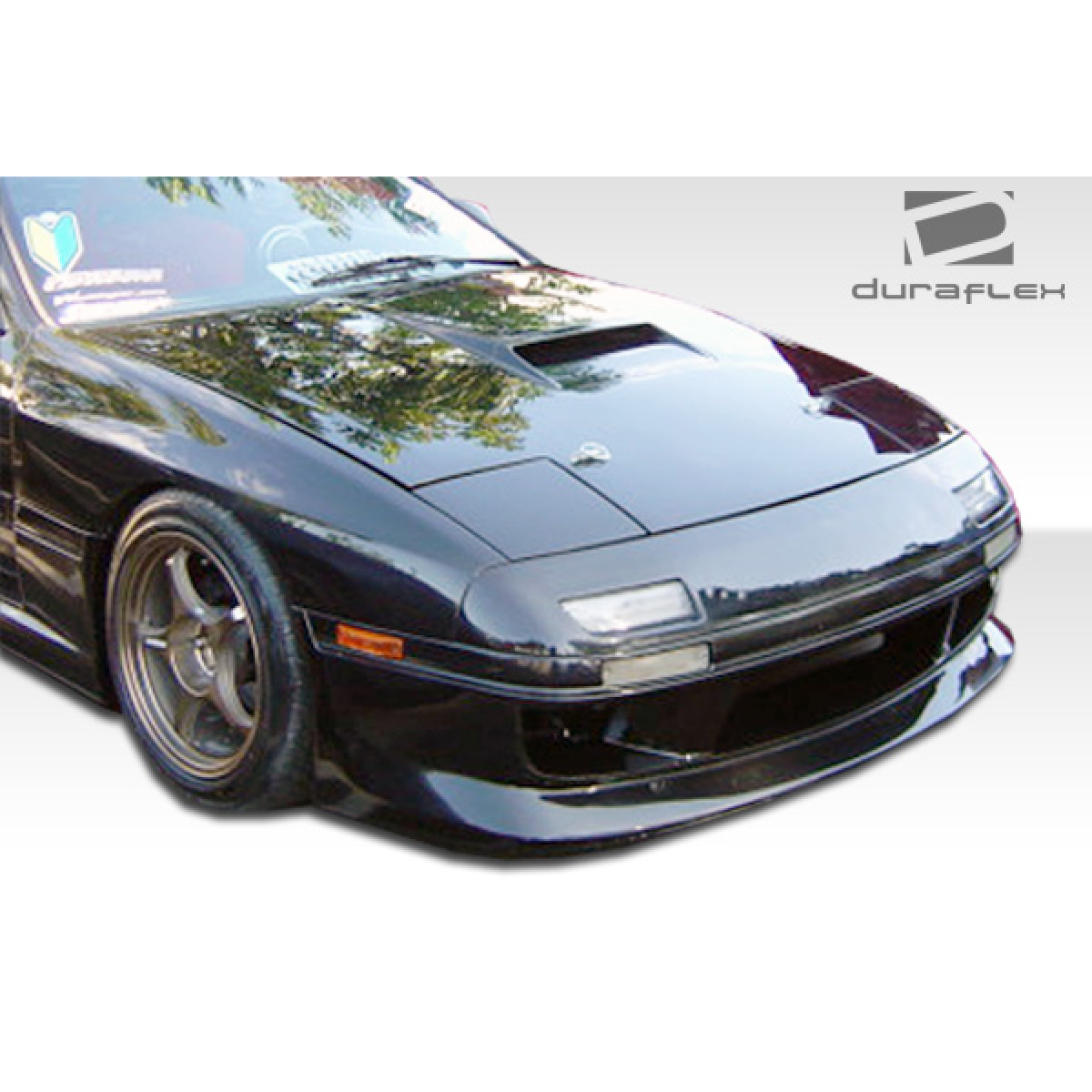 Modify your Mazda RX-7 1986 with our Exterior/Complete Body Kits - Front angle view of the body kit on a vehicle