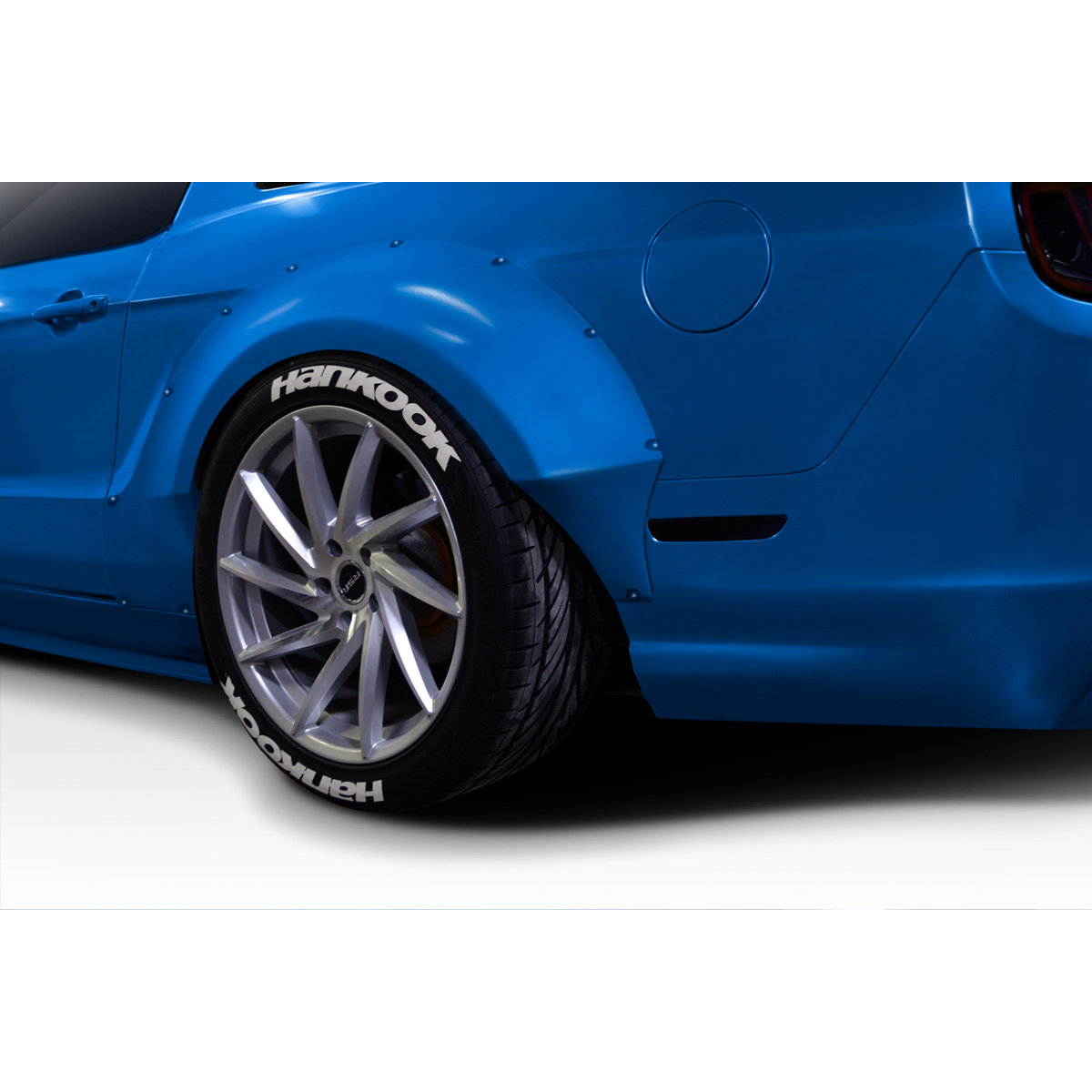 Modify your Ford Mustang 2010 with our Exterior/Fenders - Angle from rear showing fender and tire clearly