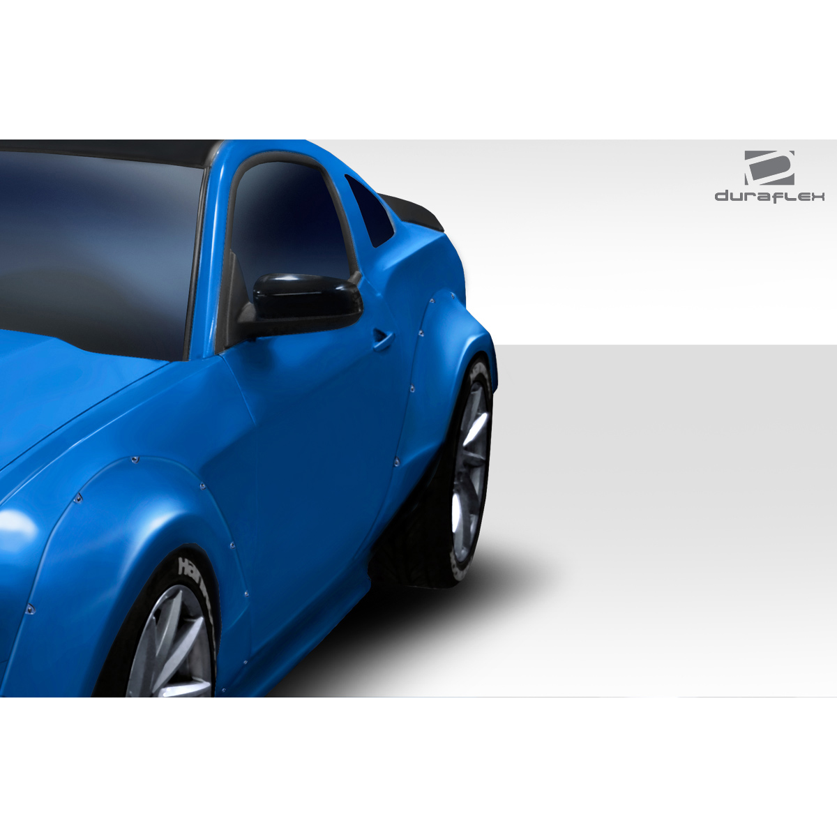 Modify your Ford Mustang 2010 with our Exterior/Fenders - Angled view of blue Mustang fender flares