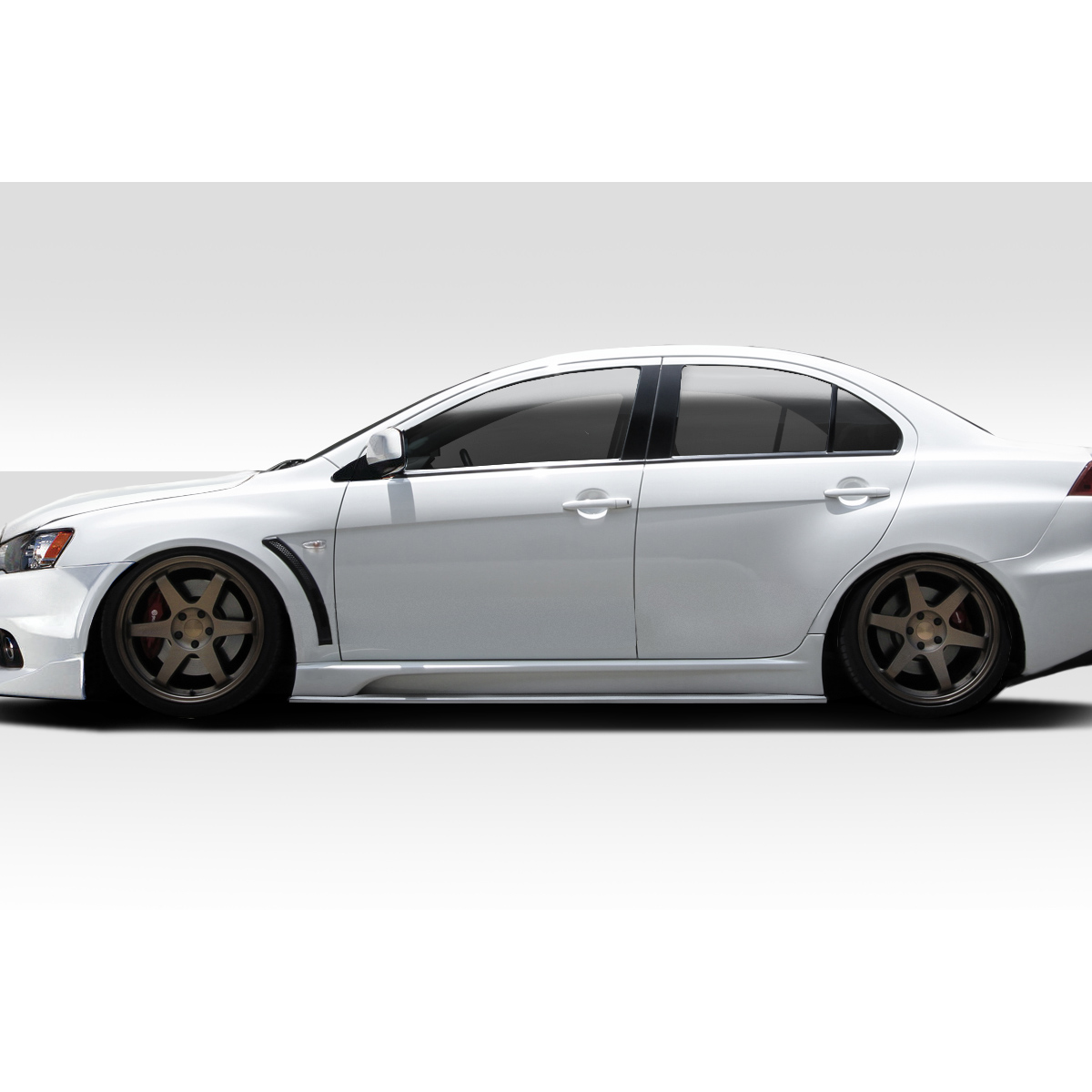 Modify your Mitsubishi Lancer 2008 with our Exterior/Side Skirts - Side view of the vehicle at a low angle