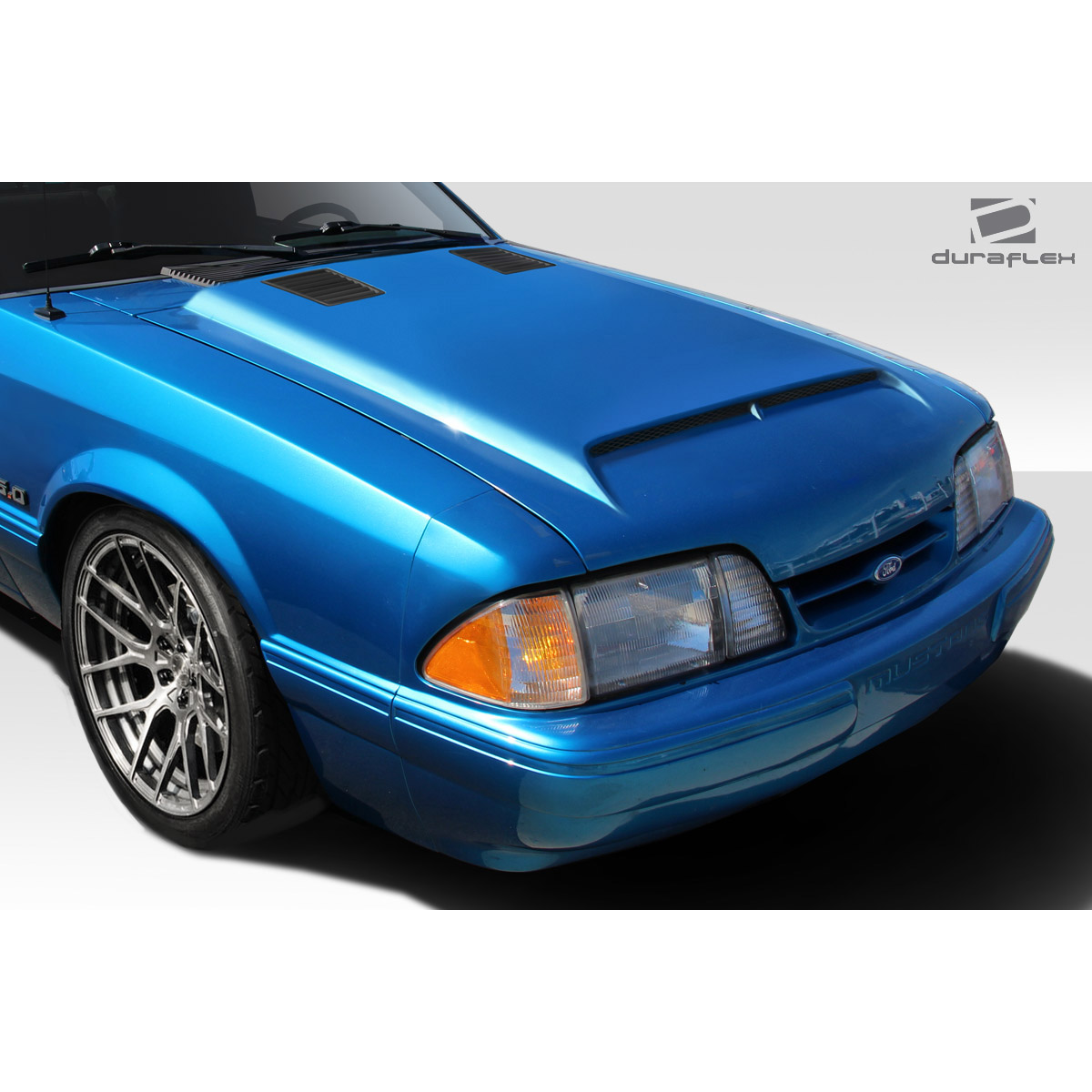 Modify your Ford Mustang 1987 with our Exterior/Hoods - Front angle view of hood on blue Mustang