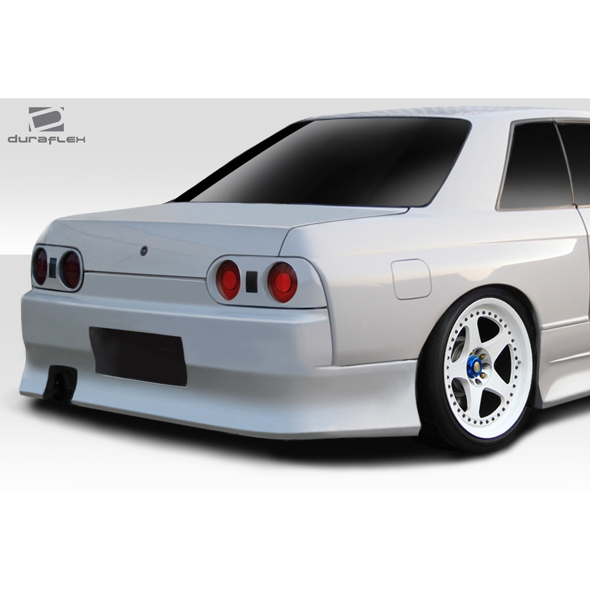 Modify your Nissan Skyline 1989 with our Exterior/Rear Bumpers or Lips - Viewed from the rear and slightly to the side