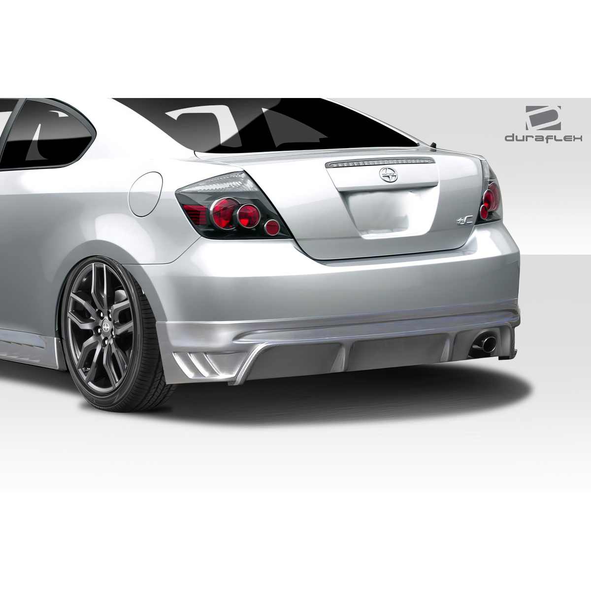 Modify your Scion tC 2005 with our Exterior/Rear Bumpers or Lips - Viewed from a low rear angle showcasing the bumper