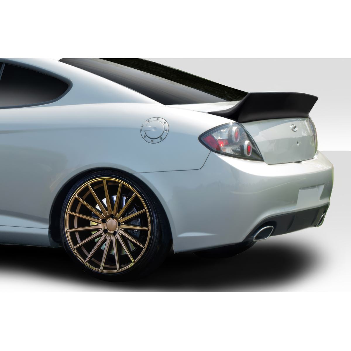 Modify your Hyundai Tiburon 2003 with our Exterior/Wings - The angle shows the rear left of the vehicle