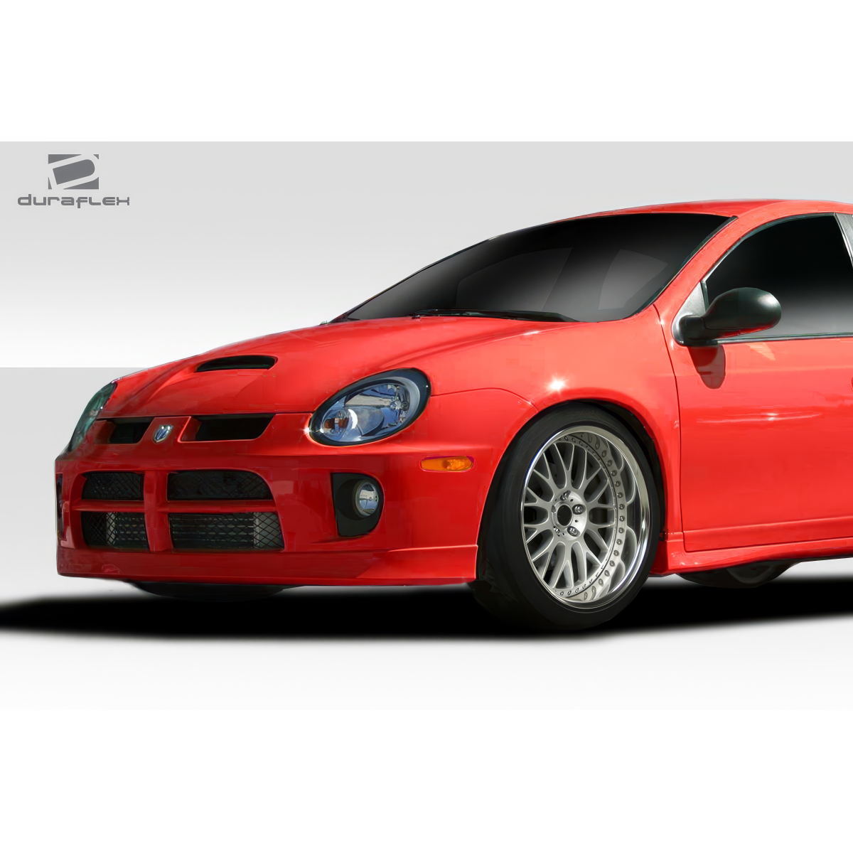 Modify your Dodge Neon 2003 with our Exterior/Front Bumpers or Lips - Front angle view of bumper on a red Dodge Neon