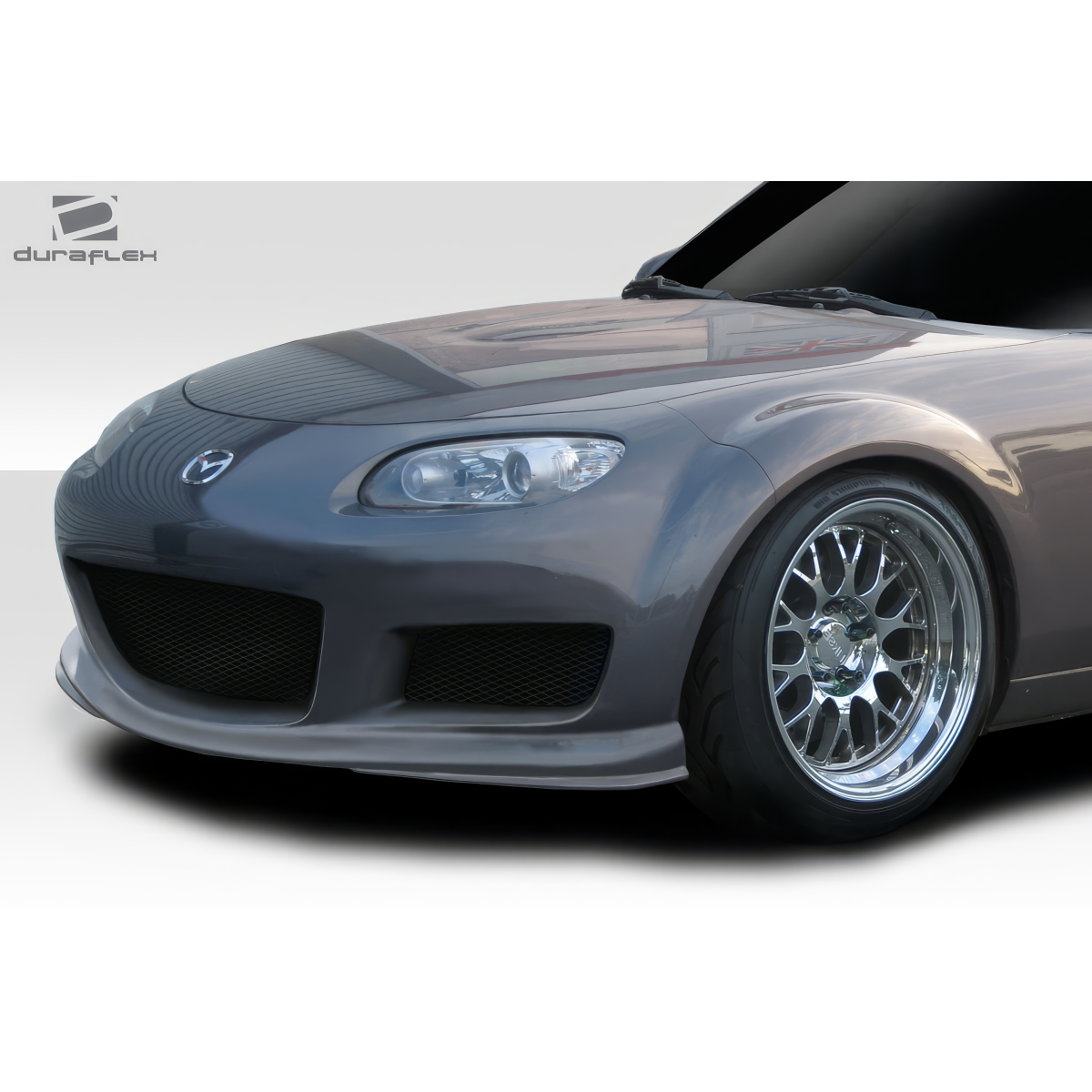 Modify your Mazda Miata 2006 with our Exterior/Front Bumpers or Lips - Front angle view of the bumper and wheel