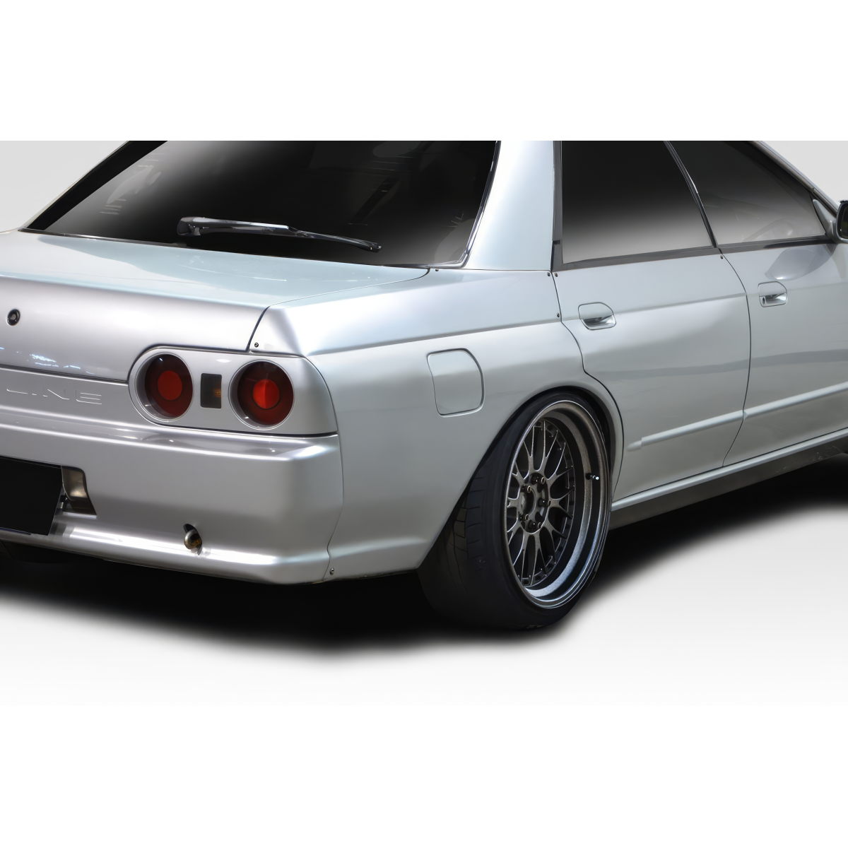 Modify your Nissan Skyline 1989 with our Exterior/Fenders - Image shows rear angle of silver Nissan Skyline