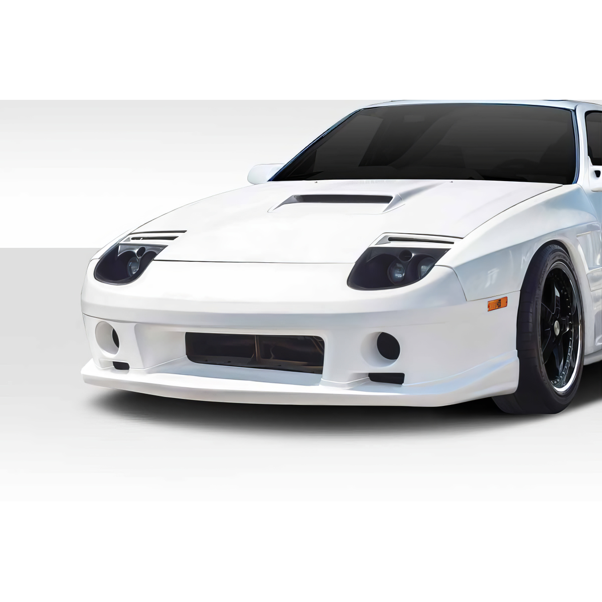 Modify your Mazda RX-7 1986 with our Exterior/Front Bumpers or Lips - Front angle view of white RX-7 with focused detail