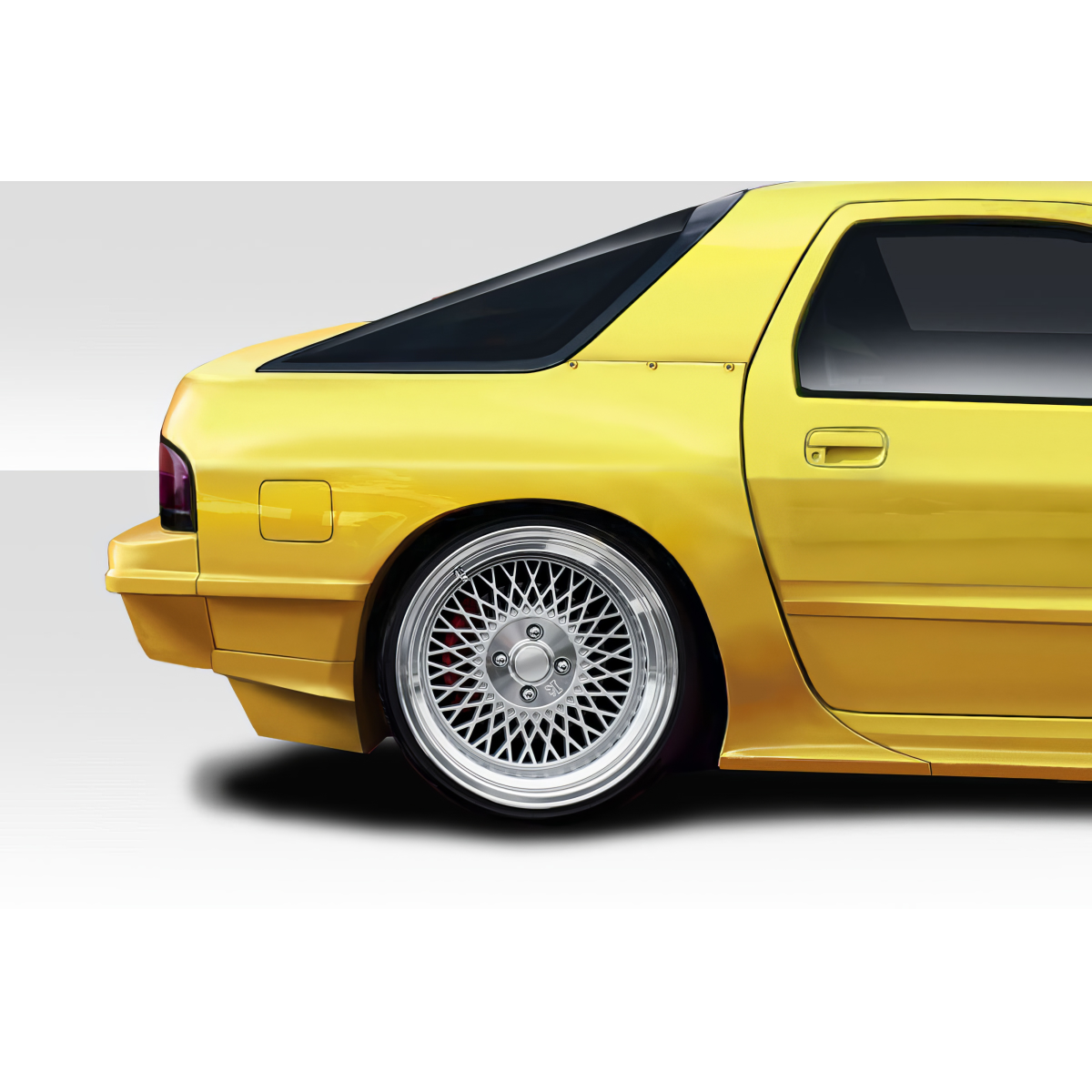 Modify your Mazda RX-7 1986 with our Exterior/Fenders - Side angle view of the rear fender and wheel