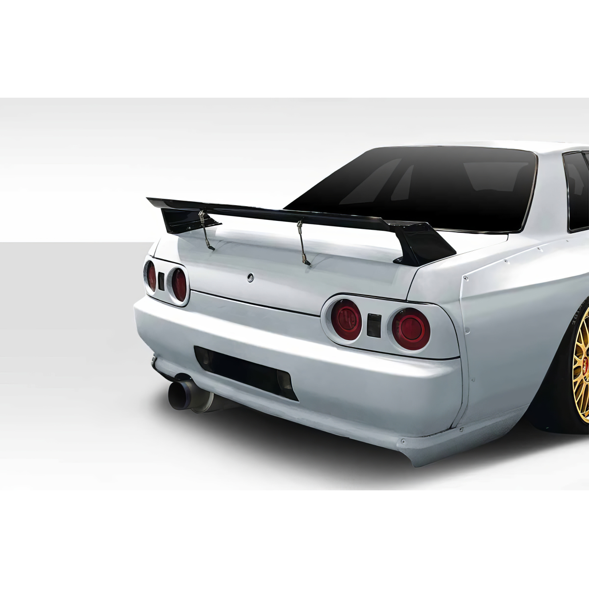 Modify your Nissan Skyline 1989 with our Exterior/Wings - Rear angle view of vehicle featuring wing and exhaust