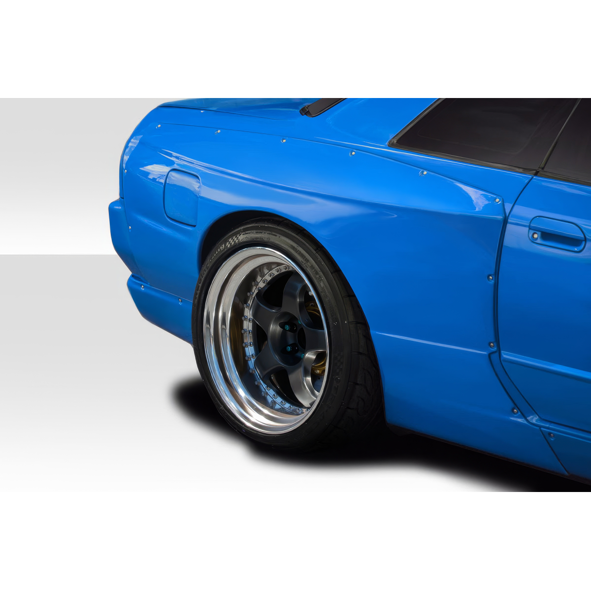 Modify your Nissan Skyline 1989 with our Exterior/Fenders - Rear angled view of blue Nissan Skyline R32 fender