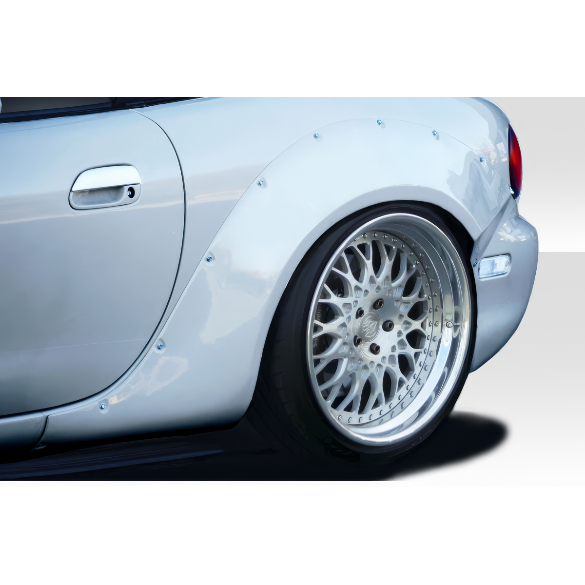 Modify your Mazda Miata 1999 with our Exterior/Fenders - Angled view of rear fender with wide body flare