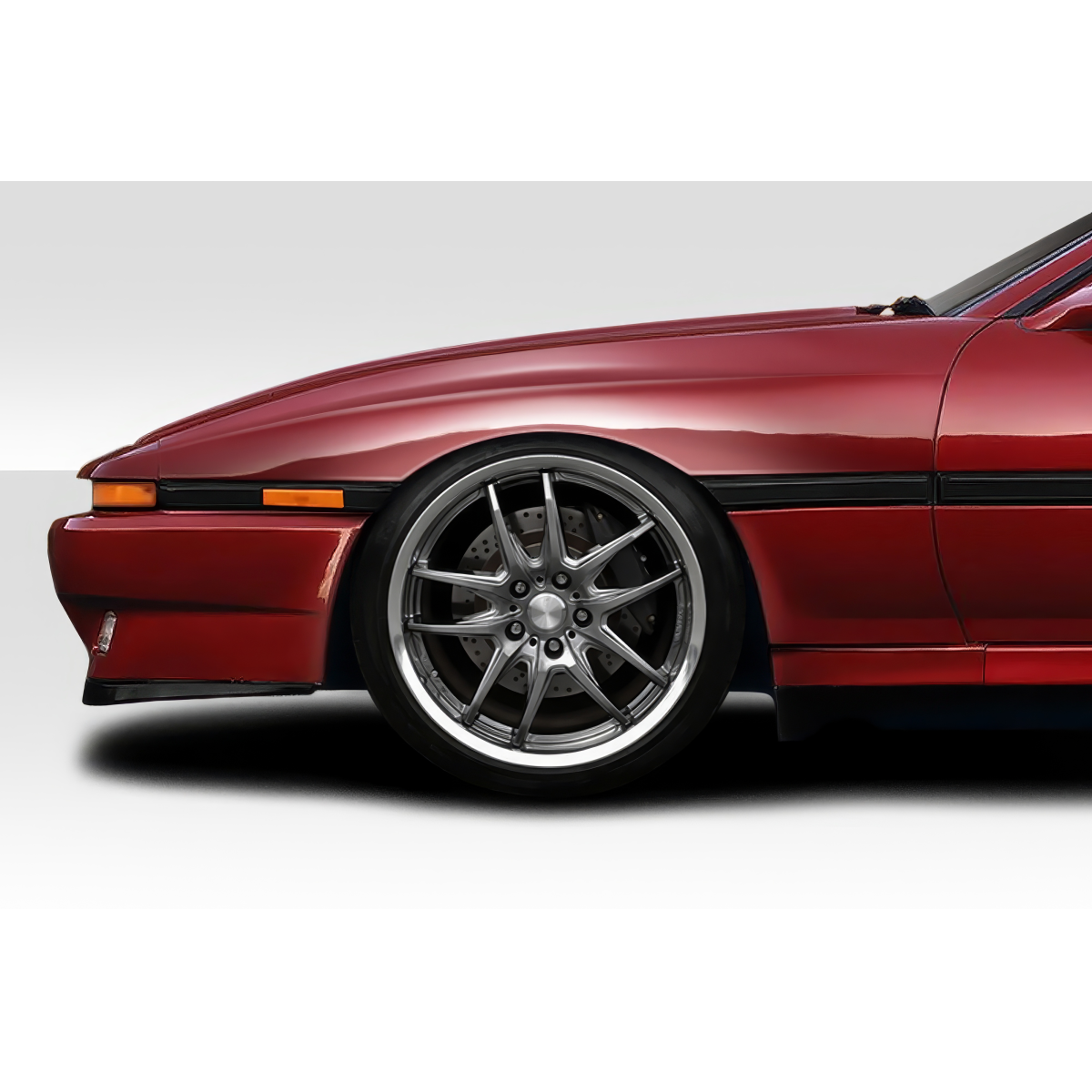 Modify your Toyota Supra 1986 with our Exterior/Fenders - Side angle view of vehicle fender and wheel