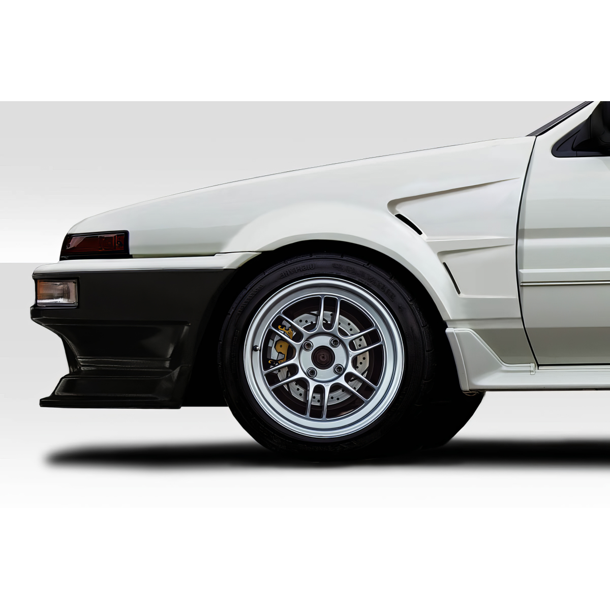 Modify your Toyota Corolla 1984 with our Exterior/Fenders - Side angle view of car fender and wheel