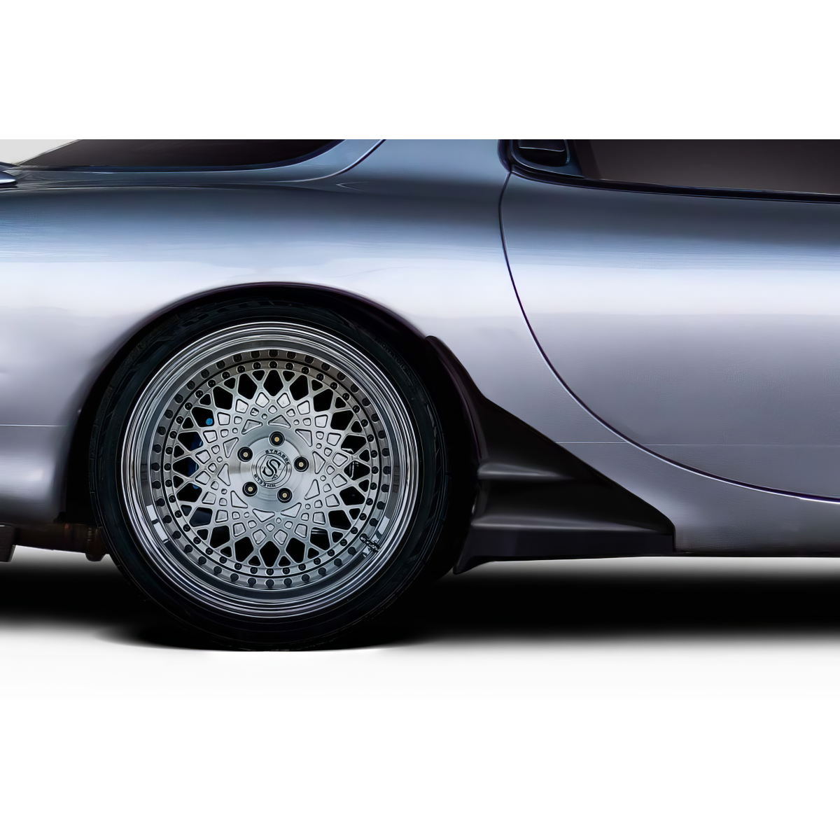 Modify your Mazda RX-7 1993 with our Exterior/Rear Bumpers or Lips - Image shows rear wheel at a side angle